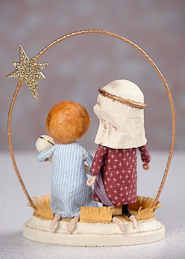 Back view of Lori Mitchell nativity figurine with two figures and gold star arc
