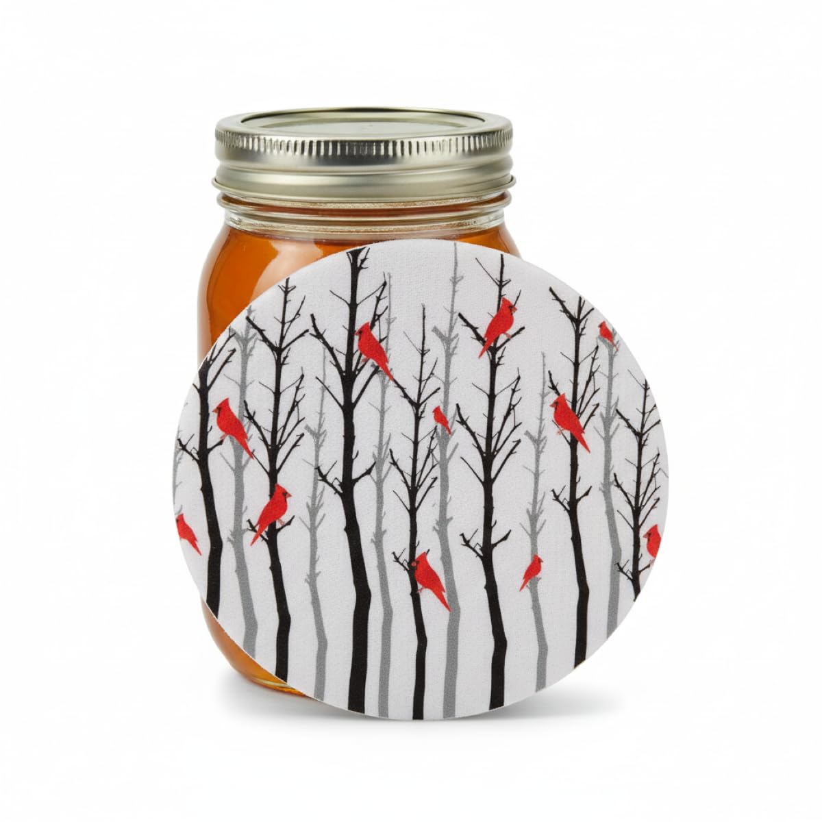 Cardinal Forest silicone jar opener leaning against a mason jar filled with honey