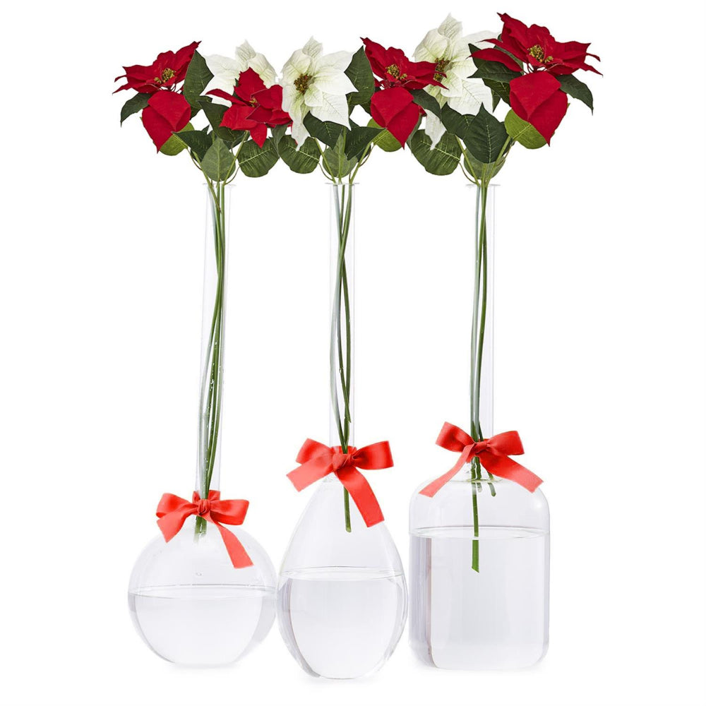 Three clear glass vases with red bows holding red and white faux poinsettia stems