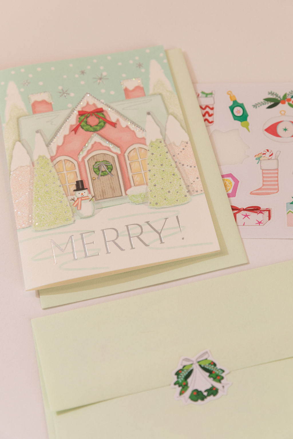 Karen Adams Designs Merry House greeting card with snowman, wreath, and mint green envelope