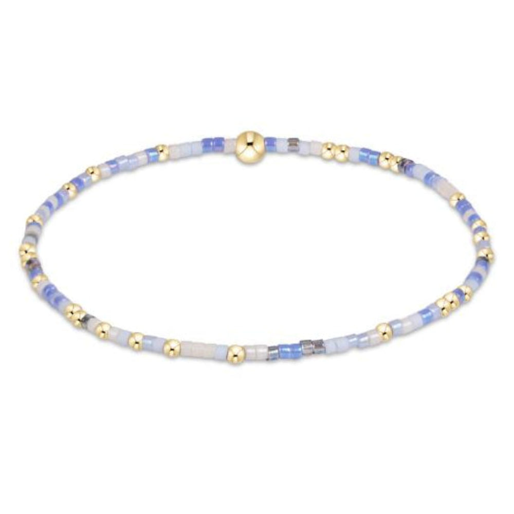 eNewton Hope Unwritten bracelet in Bloopers colorway with blue, white, and gold beads