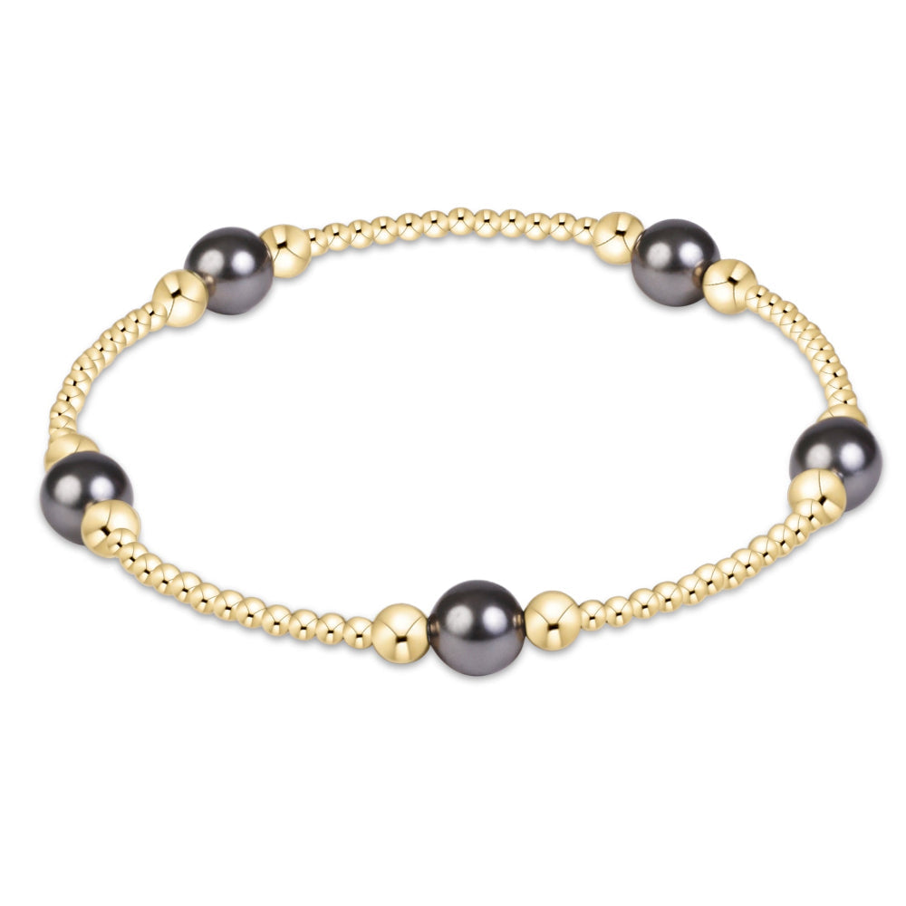 eNewton Purpose Pearl Dark Grey 6mm gold beaded stretch bracelet on white background