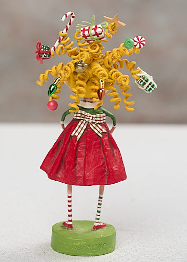 Gabby Giftmas figurine with wild curly hair adorned with Christmas ornaments wearing red dress
