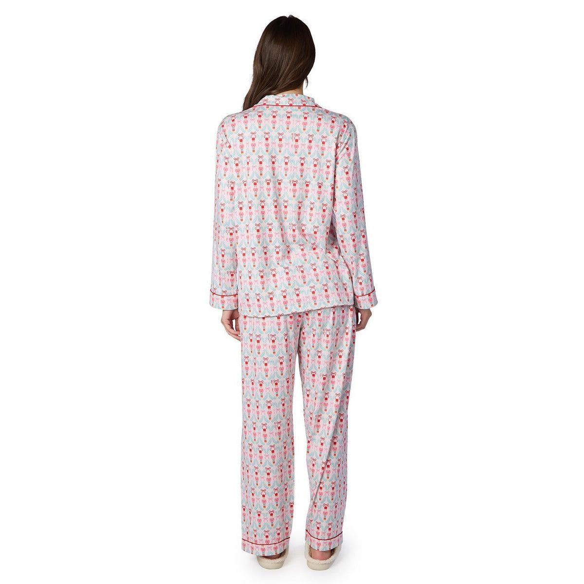 Back view of model wearing nutcracker print pajama set with long sleeves and pants