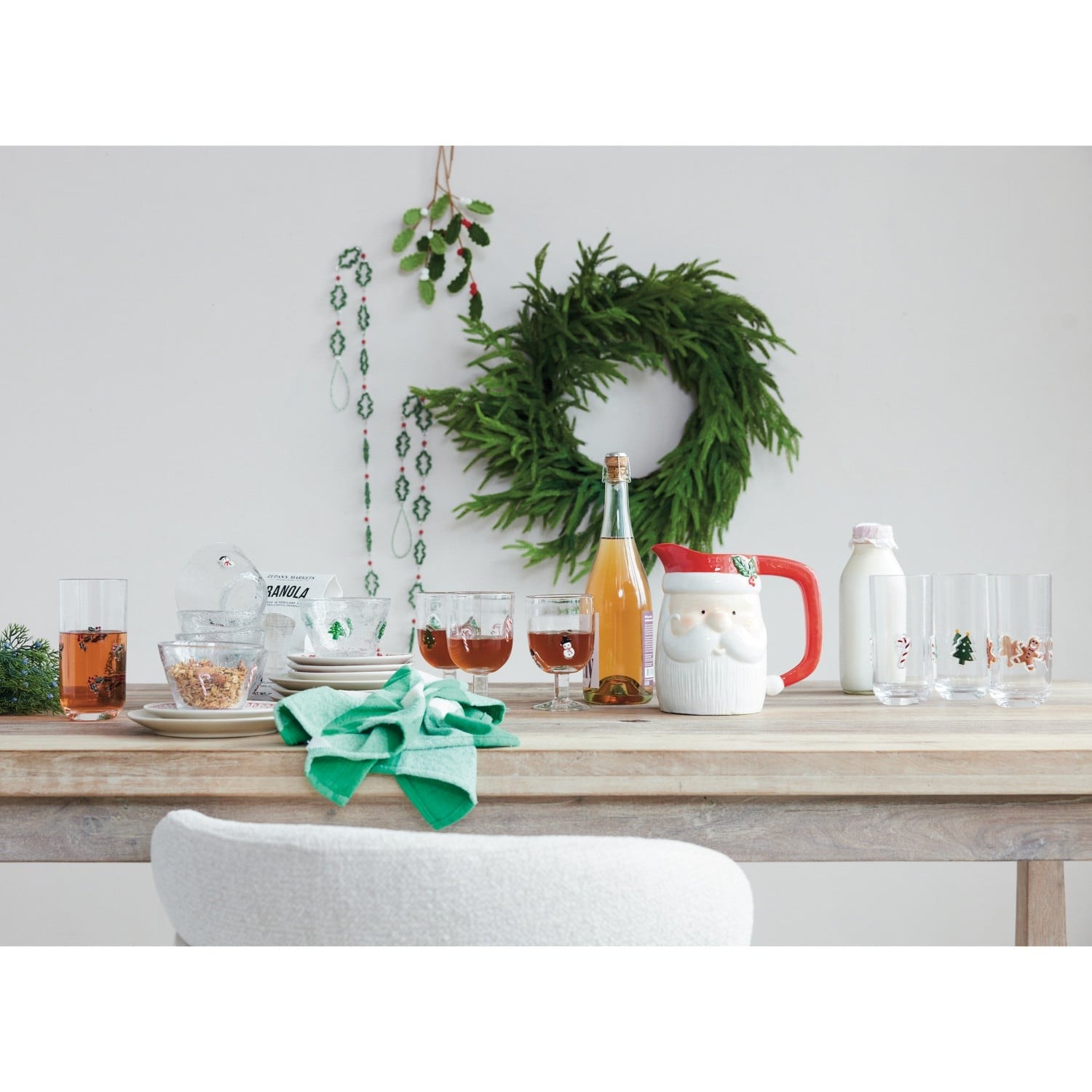 Holiday Christmas table setting featuring glass bowls with embedded holiday icons among festive tableware