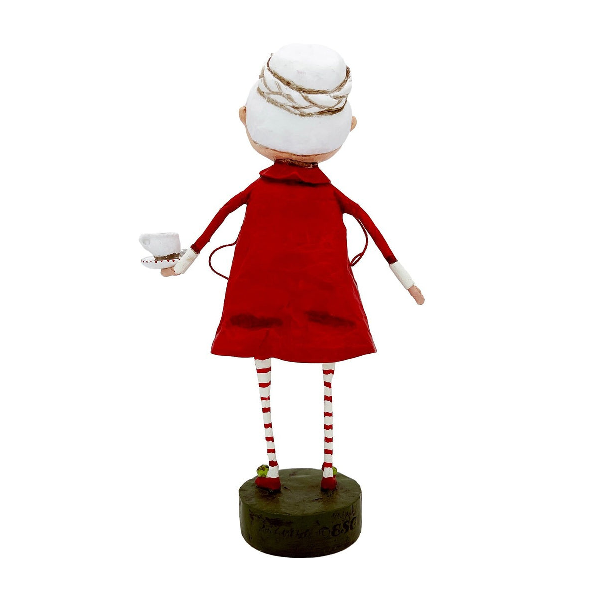 Back view of Mrs. Claus figurine in red dress with striped legs on dark base
