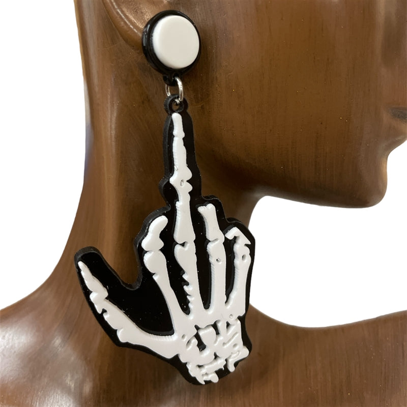 Skeleton hand middle finger earring in black and white displayed on wooden mannequin ear