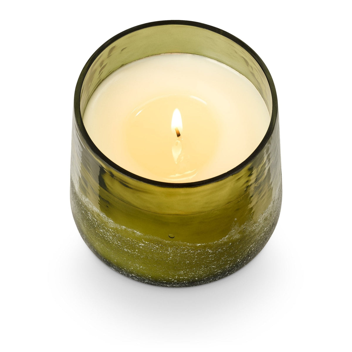 ILLUME Balsam and Cedar Baltic Glass Candle in olive green glass vessel with lit flame