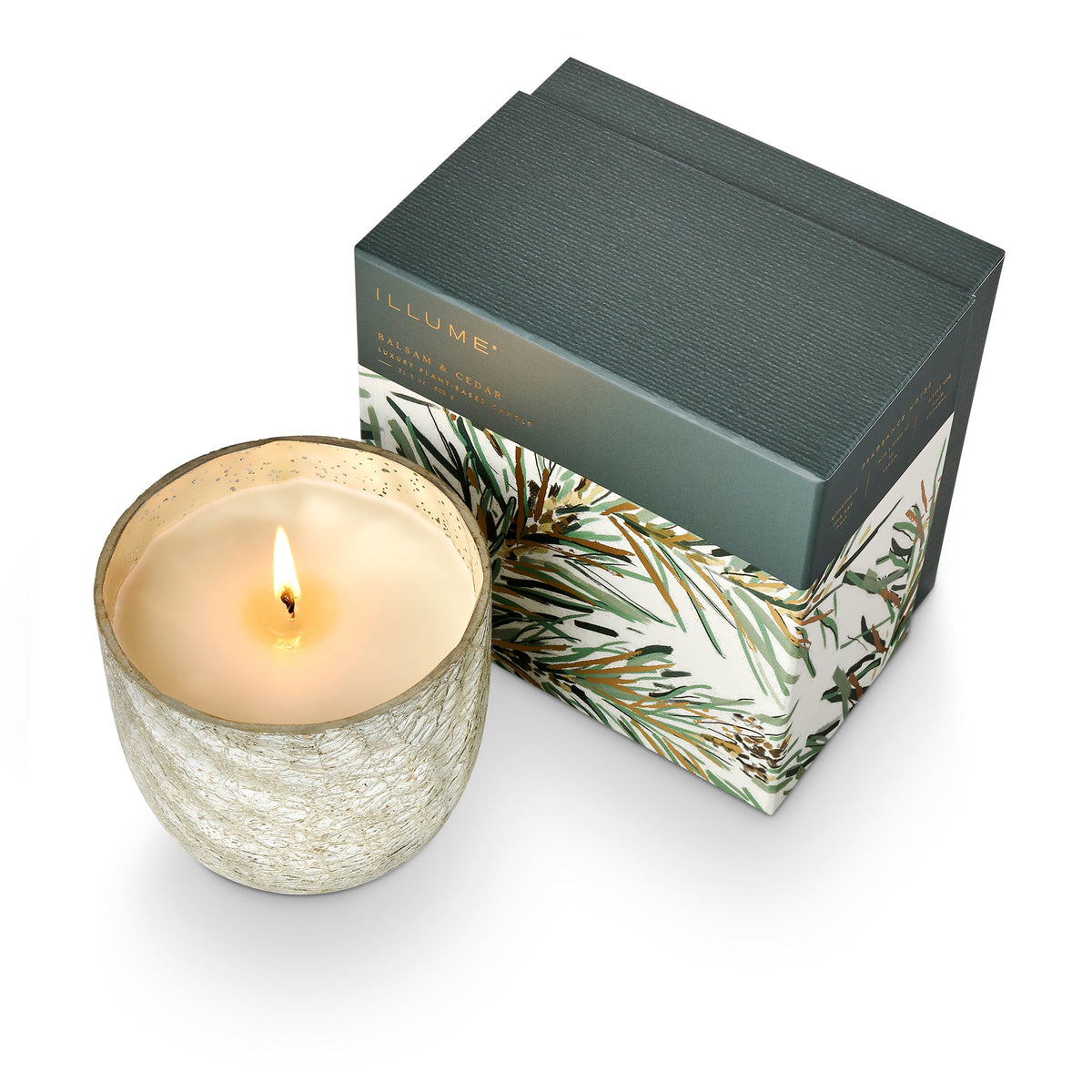 ILLUME Balsam and Cedar large crackle glass candle lit beside its decorative gift box
