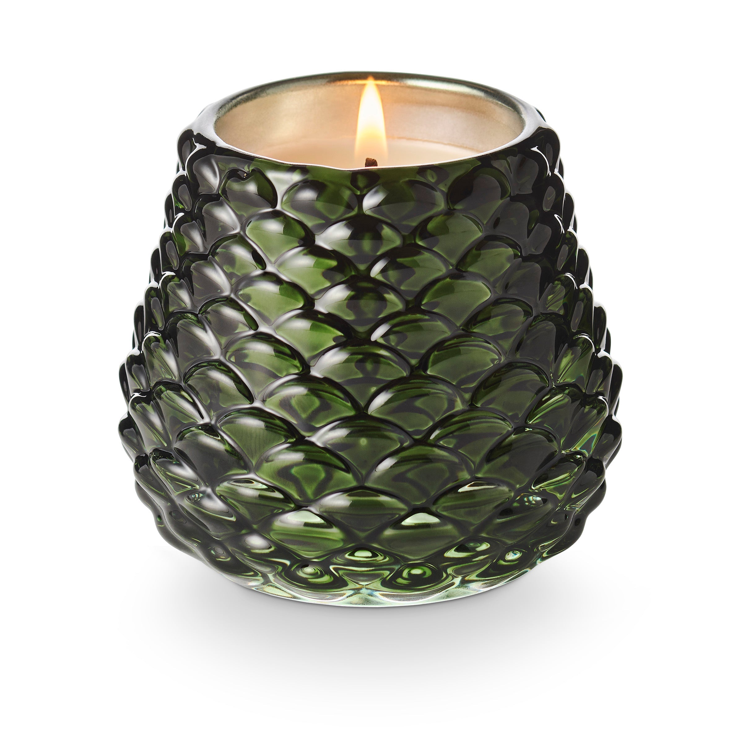 Illume Balsam and Cedar scented candle in green glass pinecone-shaped vessel with lit flame