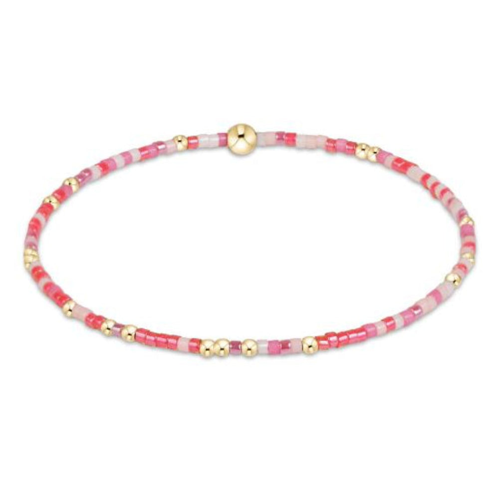 eNewton Hope Unwritten bracelet with pink and red seed beads and gold accent beads on white background