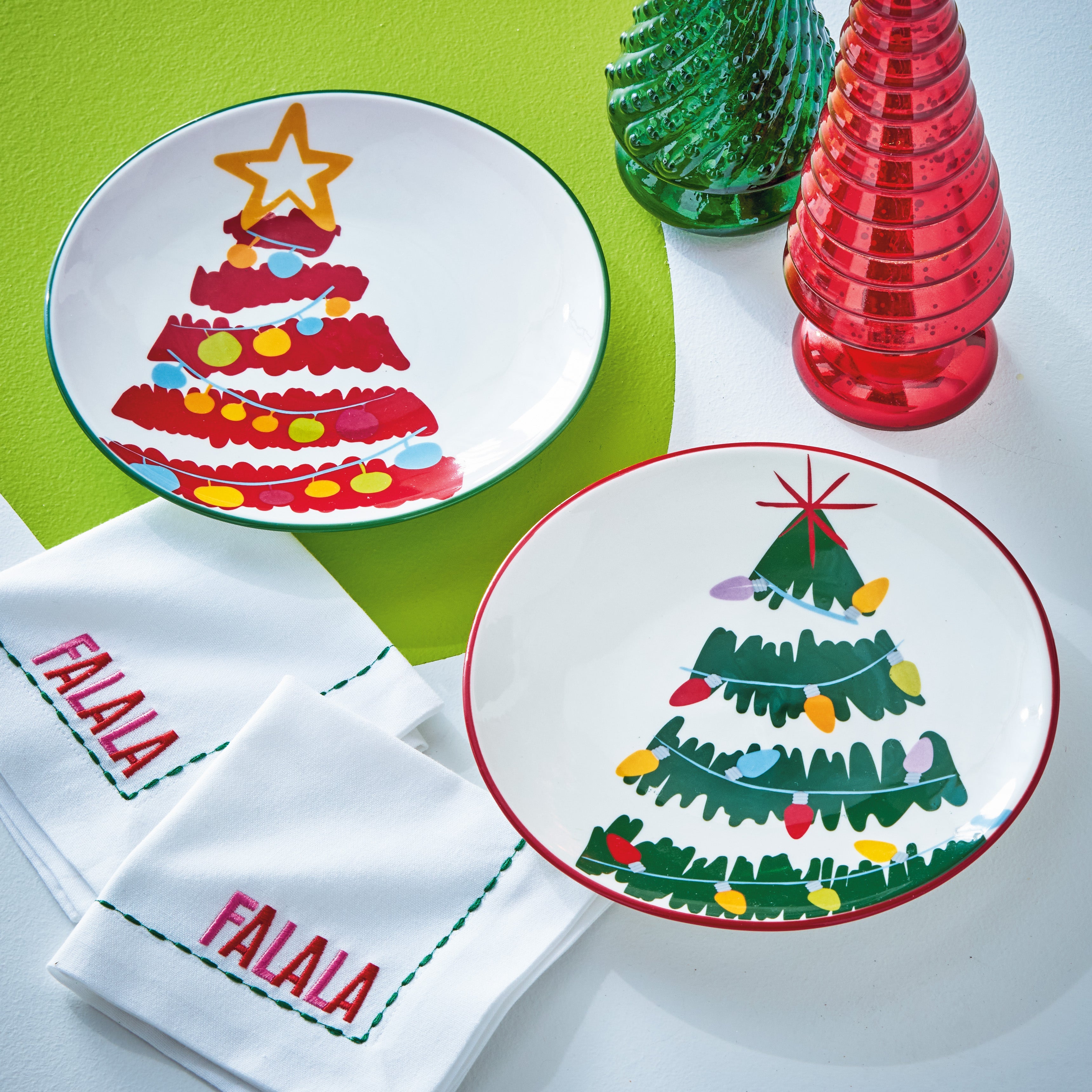 Two TAG Groovy Trees Christmas appetizer plates with festive tree designs and FALALA napkins