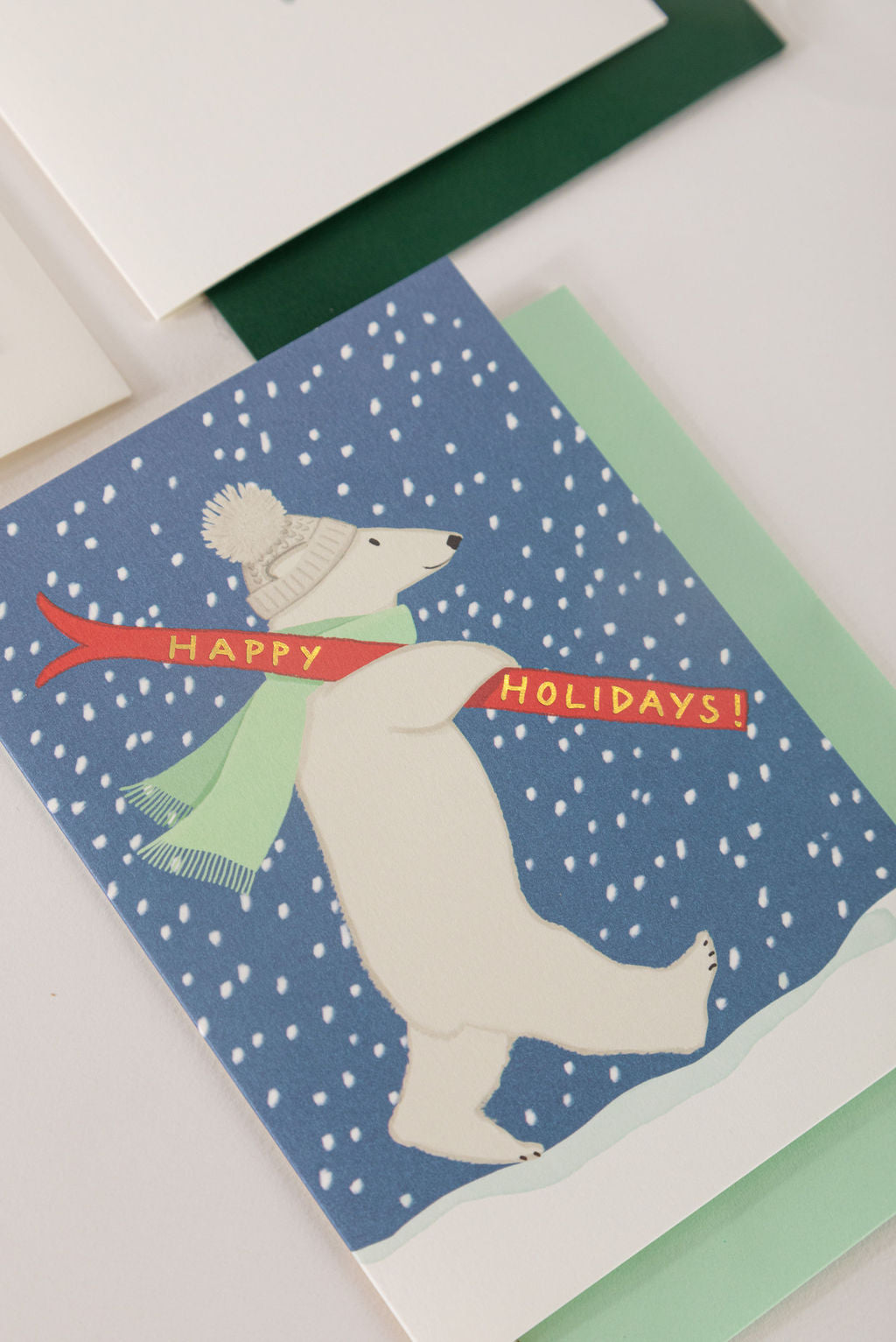 Karen Adams Designs polar bear Happy Holidays greeting card with snowy blue background and envelopes
