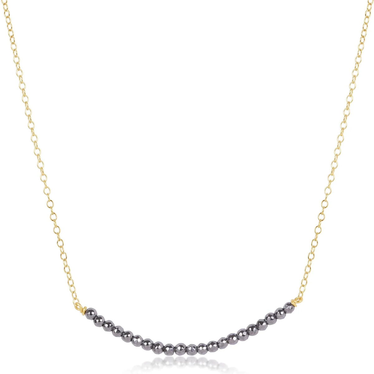 Gold chain necklace featuring a curved bar of dark faceted hematite beads at center