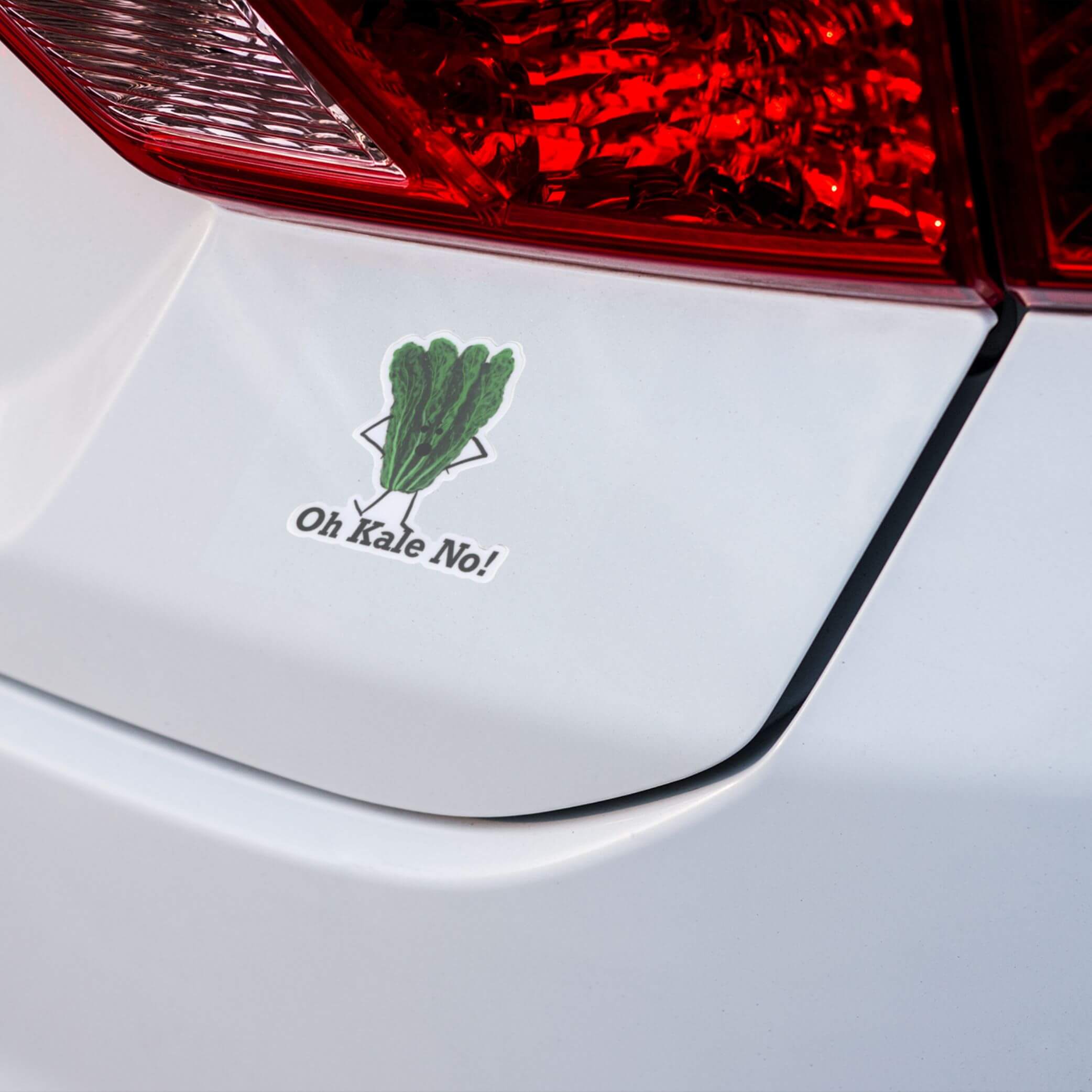 Oh Kale No humorous kale character sticker applied to white car bumper near taillight