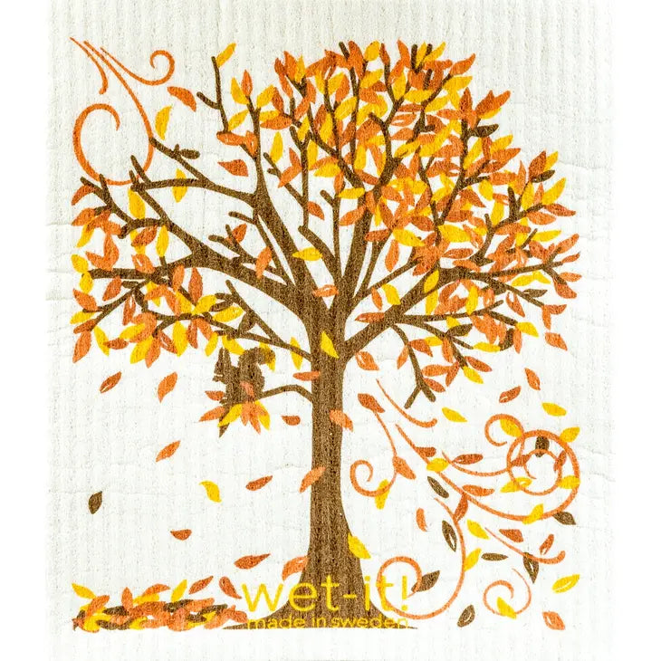 Wet-It Swedish cloth featuring a fall tree with orange and yellow autumn leaves blowing in the wind