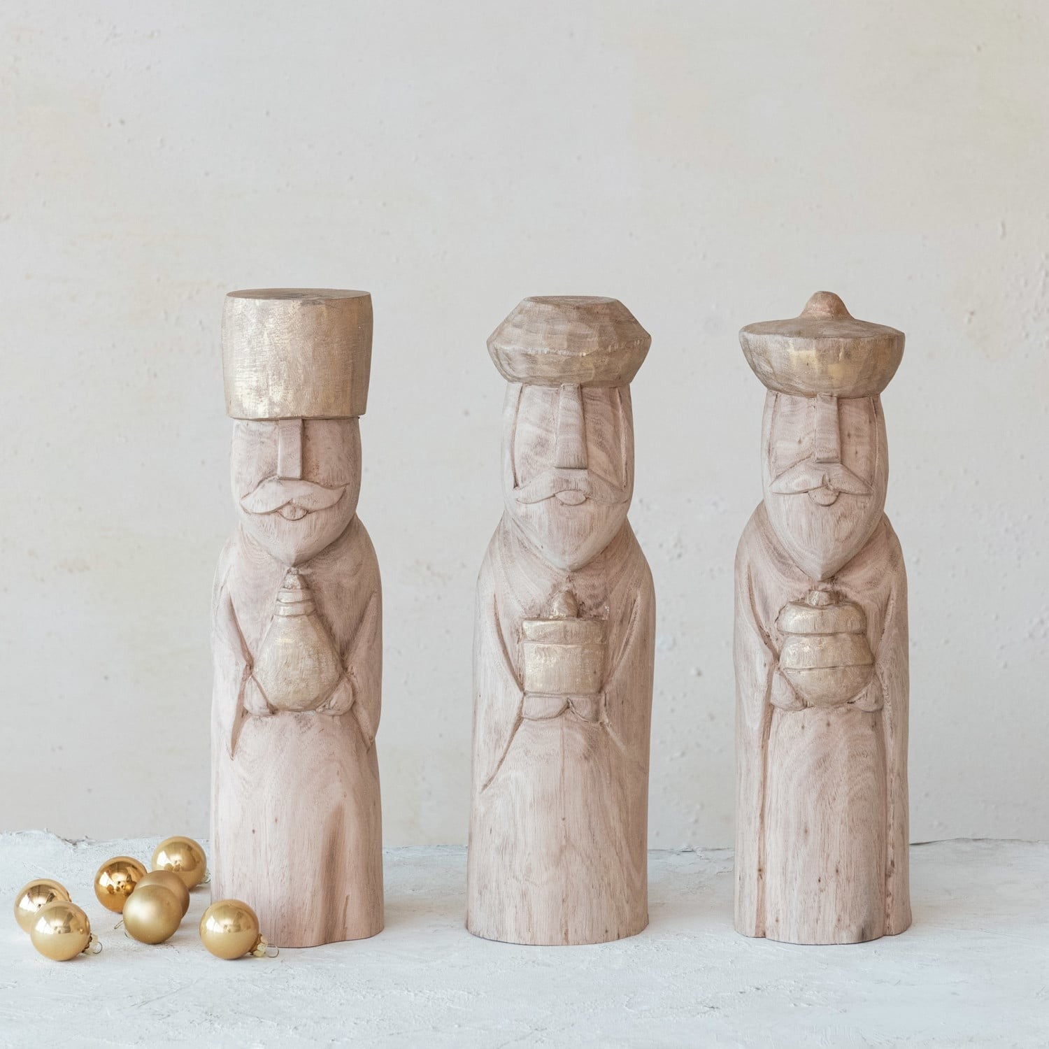 Set of three carved mango wood Wise Men figurines with gold accents and Christmas ornaments