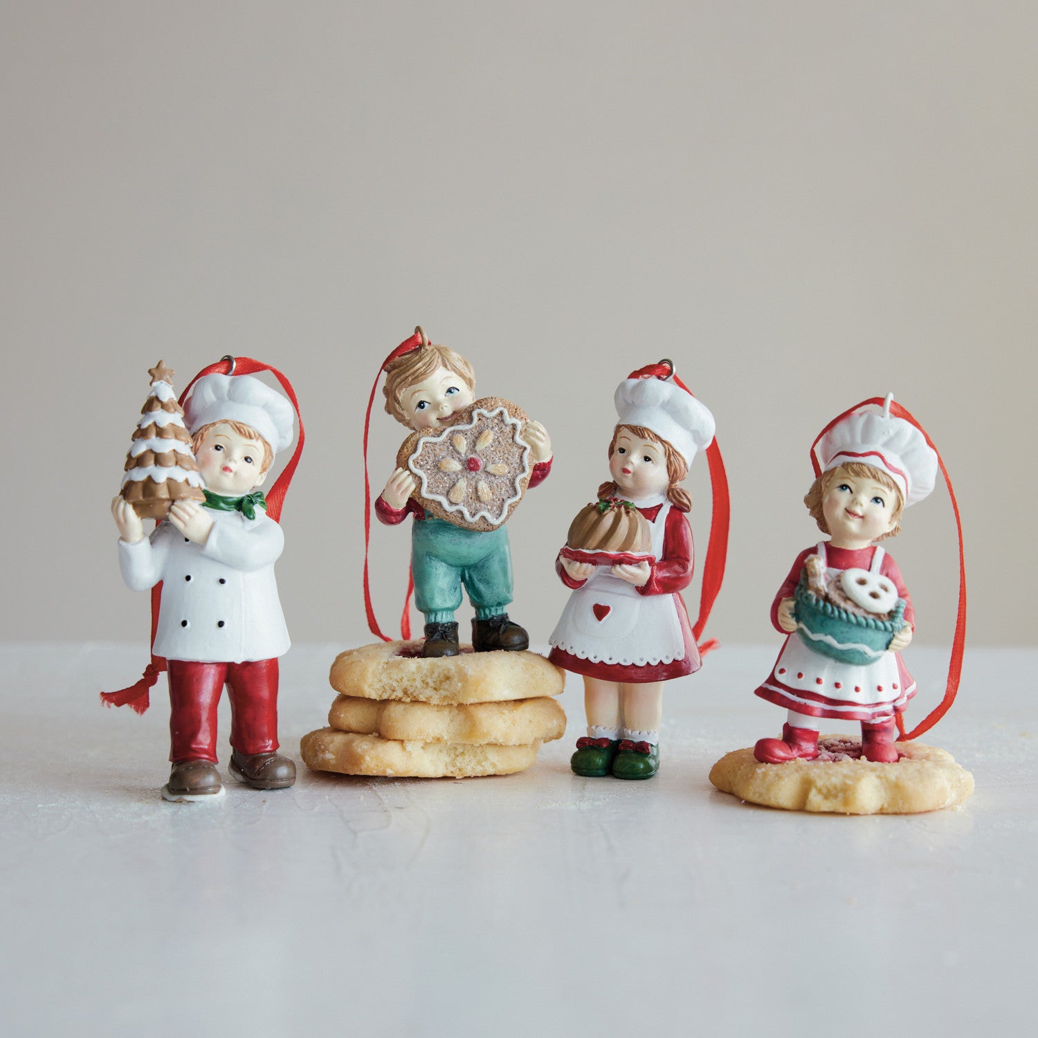 RESIN CHILD W/GINGERBREAD ORNAMENT